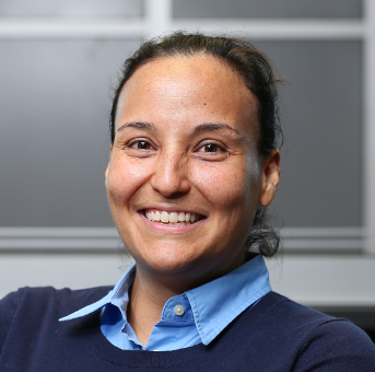 Picture of Gabriella Mosquera, with a smiling face, in front of a dark background.